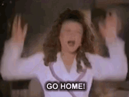 a woman is screaming and saying `` go home '' while holding her hands up .