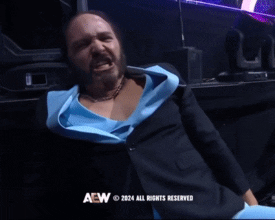 a man in a blue shirt is screaming with aew 2024 all rights reserved on the bottom