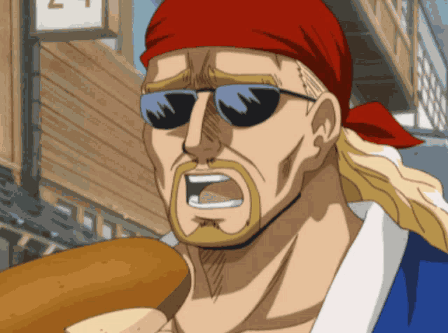 a man wearing sunglasses and a red bandana holds a loaf of bread in his hand