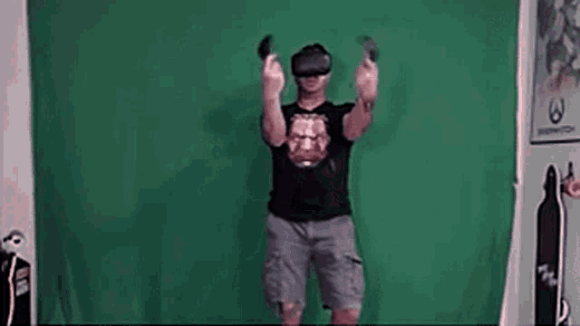 a man is wearing a virtual reality headset and holding a controller .