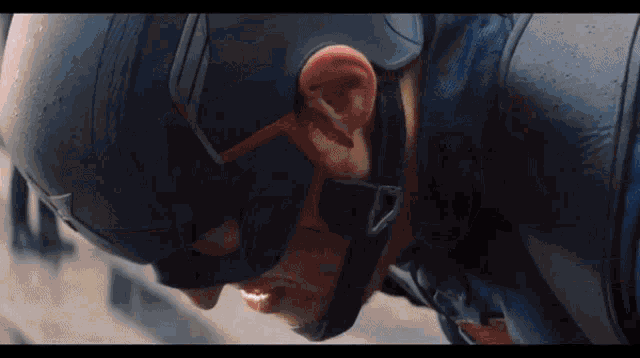 a close up of a man wearing a captain america helmet with blood coming out of his ear