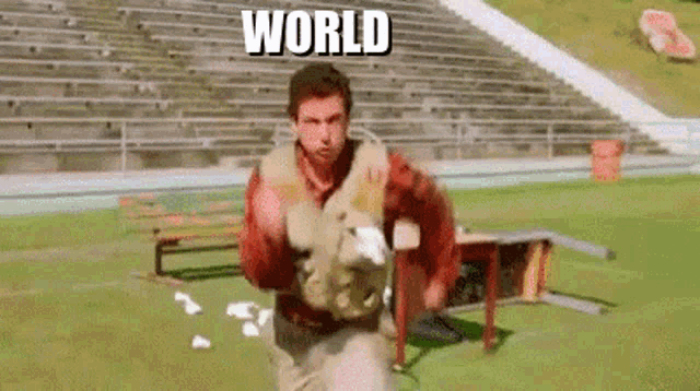 a man is running on a field with the words `` world '' written on the screen behind him .