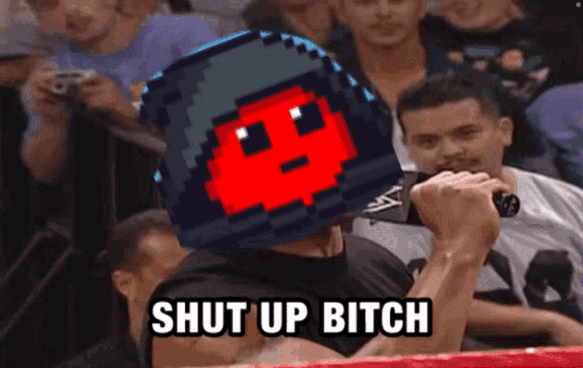 a man in a boxing ring holds a microphone and says shut up bitch in front of a crowd