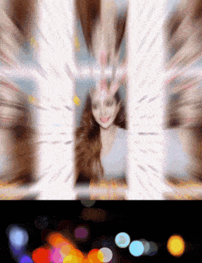 a blurry picture of a woman with a flower on her forehead