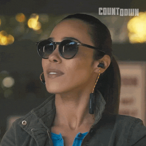 a woman wearing sunglasses and ear buds with the word countdown on the bottom