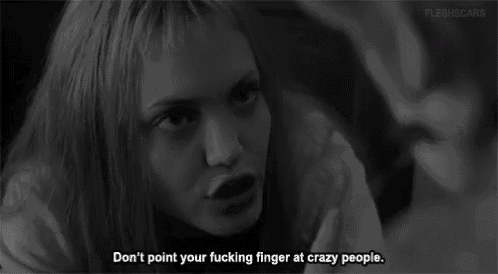 a black and white photo of a woman with the words " don t point your fucking finger at crazy people "