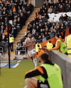 a soccer player with the number 24 on his shorts runs on the field