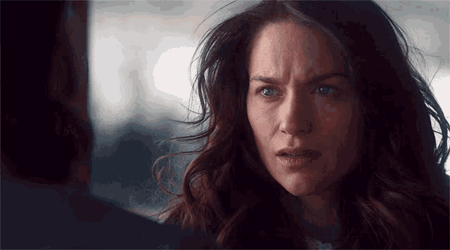 a woman with a sad look on her face looks at a man