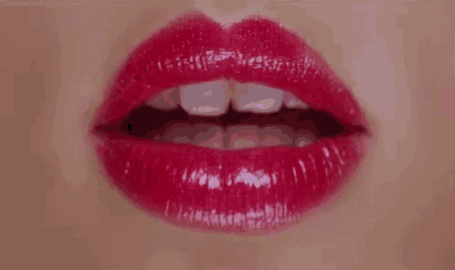 a close up of a woman 's lips with red lipstick