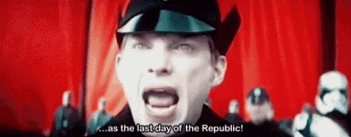 a man in a military uniform is screaming in front of a red curtain .