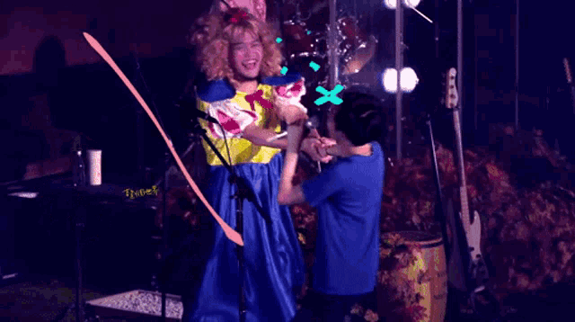 a girl in a snow white costume is holding hands with another girl in a blue shirt