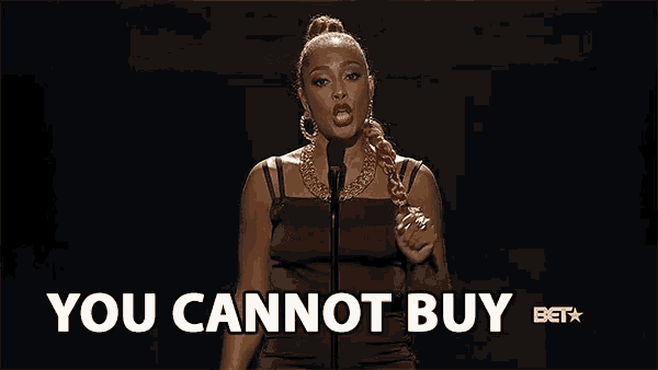 a woman singing into a microphone with the words " you cannot buy " below her