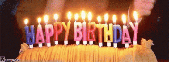 a birthday cake with a bunch of candles that say happy birthday