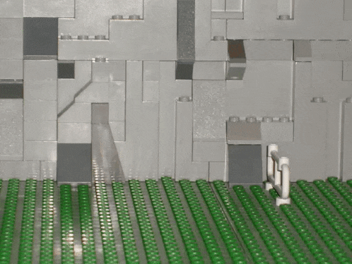 a row of green bricks are lined up on a table