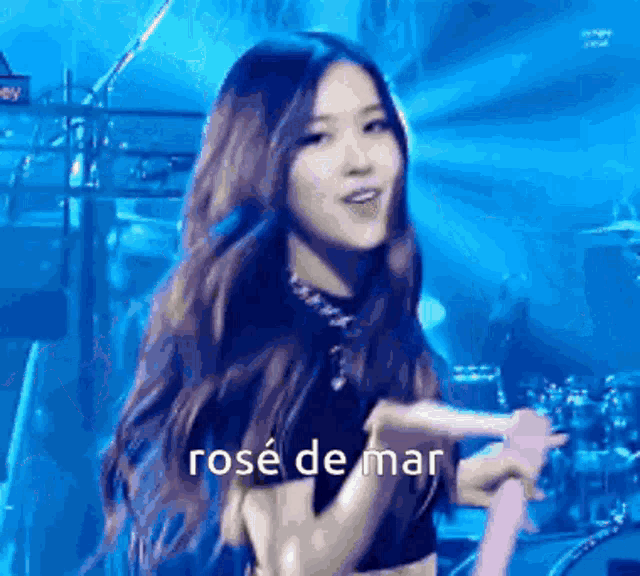 a woman is standing on a stage holding a microphone and singing .