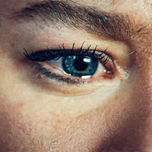 a close up of a man 's blue eye
