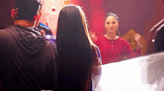 a man and a woman are looking at each other in front of a mirror with the word move on the bottom