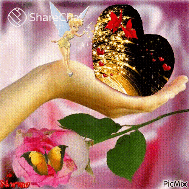 a hand holding a heart with tinkerbell on top of it
