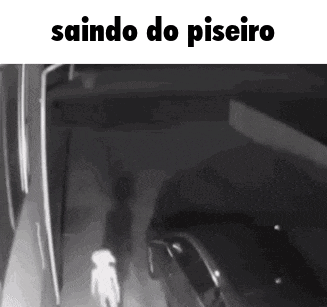 a black and white photo of a person walking in a dark room with the words saindo do piseiro on the bottom .