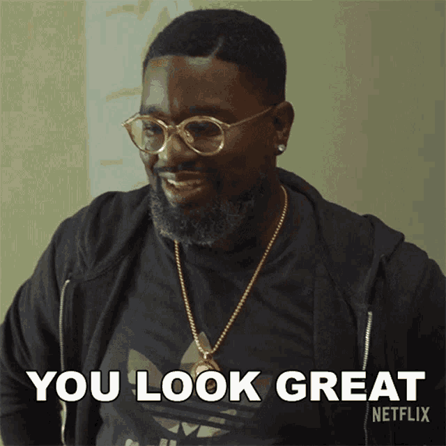 a man wearing glasses and a black shirt says you look great