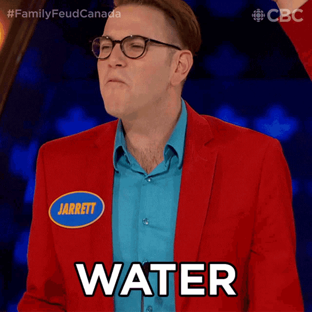 a man in a red jacket with the name jarrett on his shirt says water