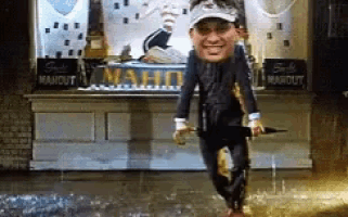a man with a big head is walking in the rain in front of a mahout store