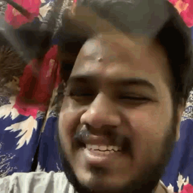 a close up of a person laying on a bed with their mouth open .