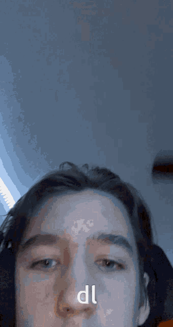 a close up of a person 's face with the letters dl written on it