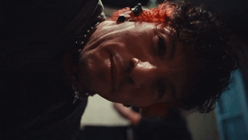 a close up of a person 's face with blood on it