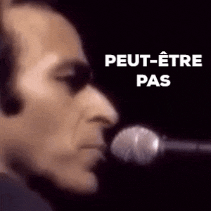 a close up of a man singing into a microphone with the words peut-etre pas written on the bottom .