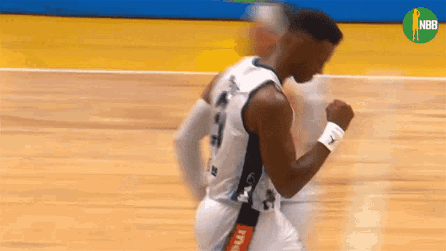a man in a basketball uniform is running on a court .