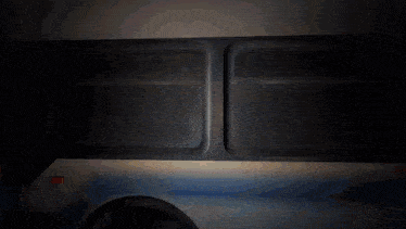 a bus with a yellow and blue stripe on the side has a window