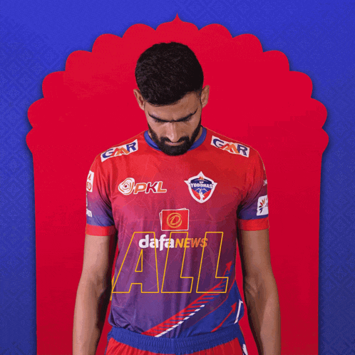 a man with a beard wears a red and blue shirt that says dafanews all