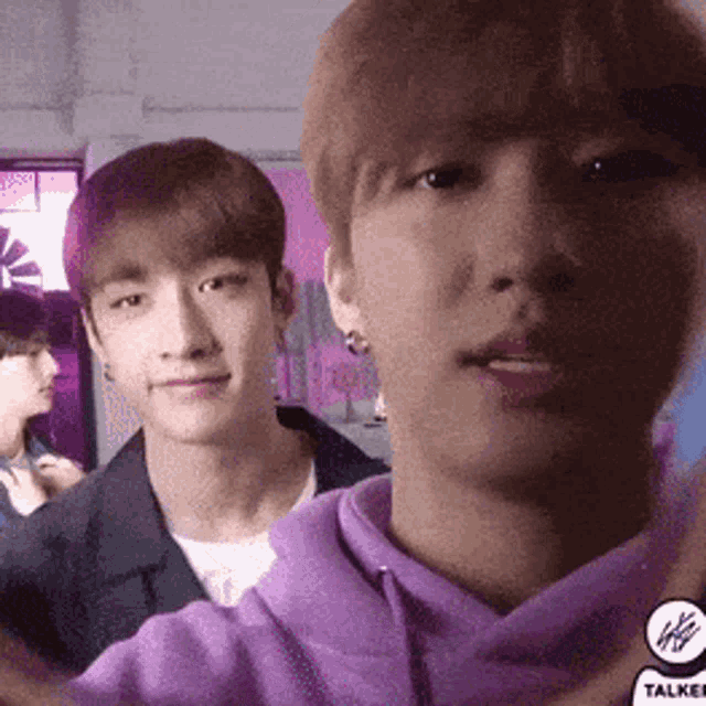 a group of young men are standing next to each other in a room .