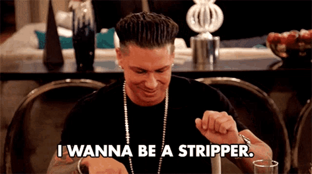a man sitting at a table with the words " i wanna be a stripper " on the screen