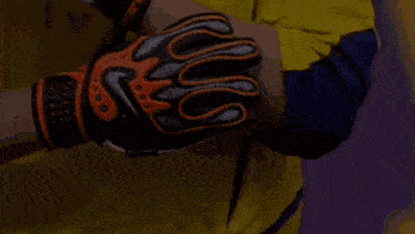 a person wearing a pair of nike gloves on their hands