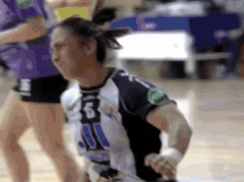 a blurred image of a woman wearing a jersey with the number 31 on it