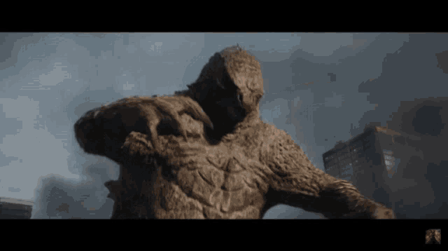 a statue of a monster with the letter r on the bottom right
