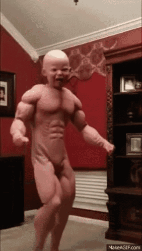 a baby in a muscle suit is dancing in front of a bookshelf