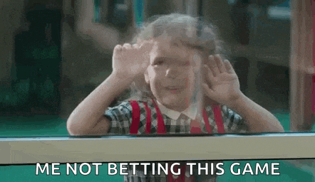 a little girl is looking out of a window and making a funny face while saying `` me not betting this game '' .
