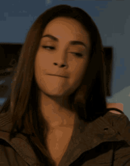 a close up of a woman 's face with her mouth open