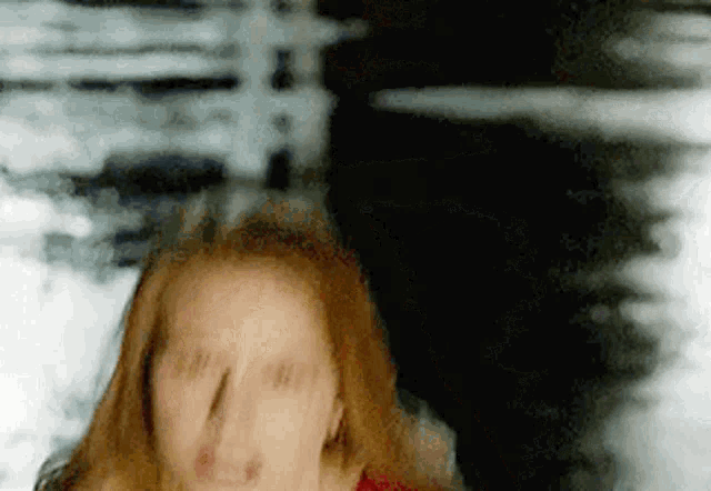 a blurry picture of a woman 's face with a shadow of a man in the background .