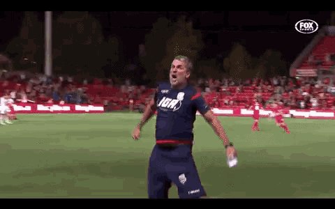 a man on a soccer field wearing a shirt that says ign on it