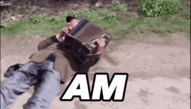 a man laying on the ground playing an accordion with the word am written on the bottom