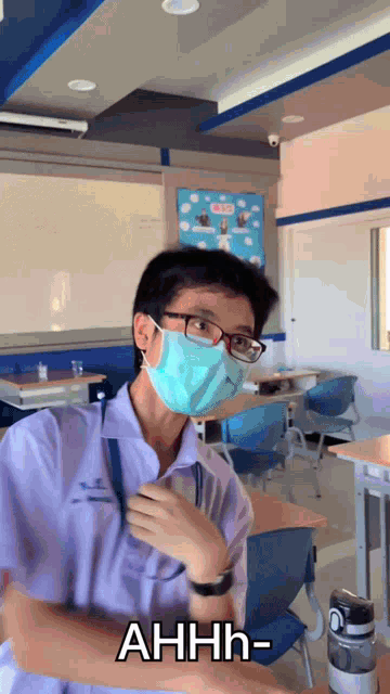 a man wearing glasses and a face mask says ahhh