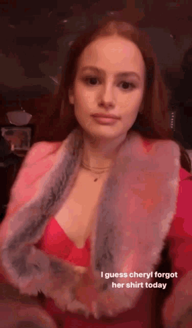 a woman is wearing a pink jacket with a fur collar