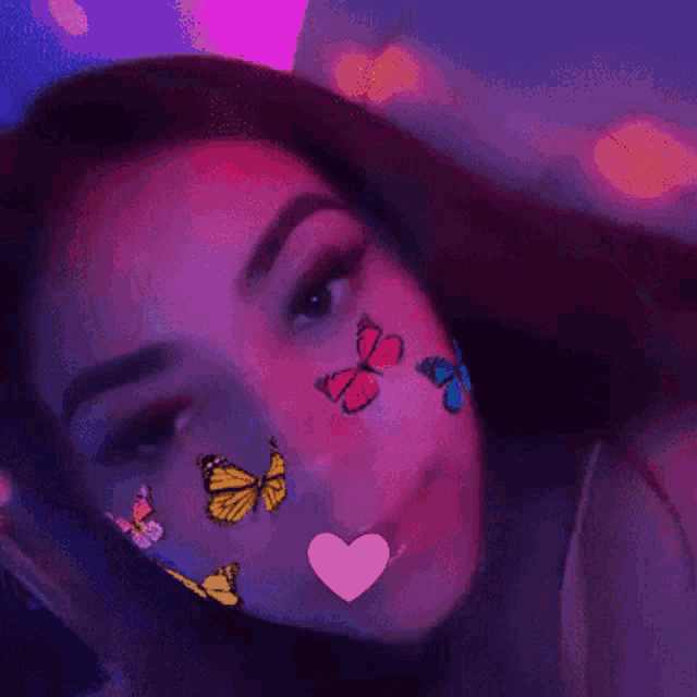 a woman with butterflies on her face and a heart