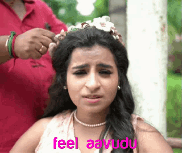 a woman with a flower crown on her head has the words feel aavudu on the bottom