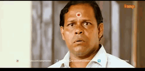 a man with a red circle on his forehead is in a scene from a movie that says saina