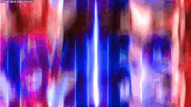 a red , blue and purple background with a blurred image of a person 's face .